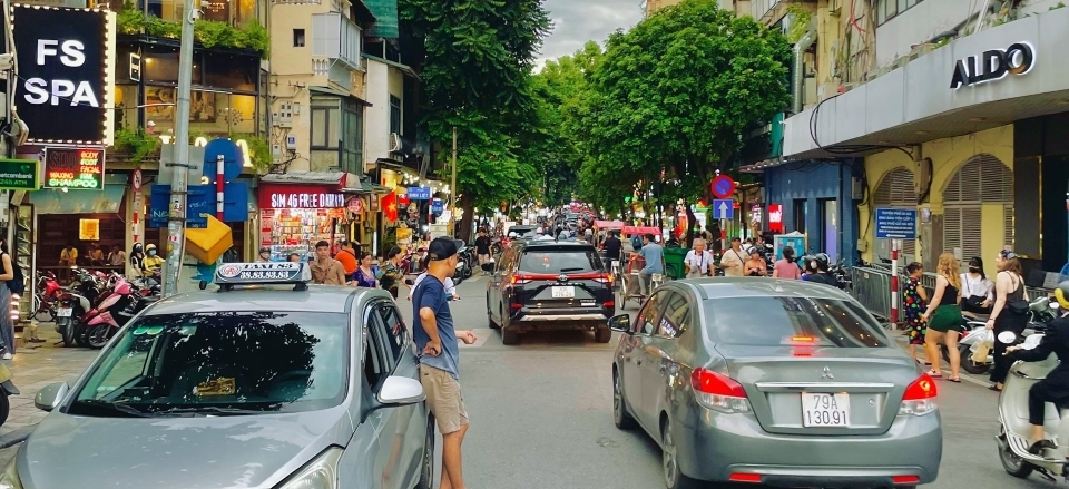 Old quarter alleyways with cars moving and shops on both side of the road