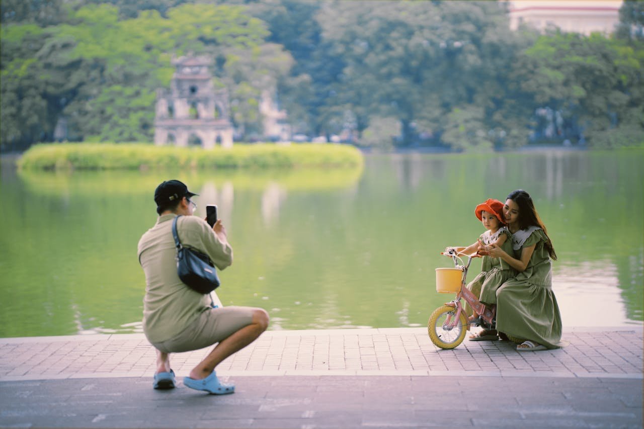 A family taking photos around Hoan Kiem Lake