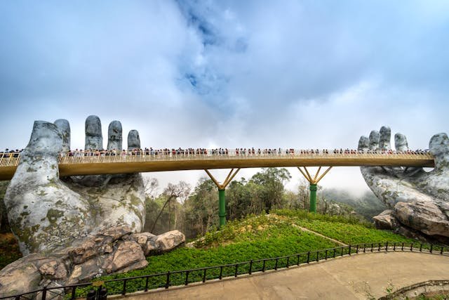 The Golden Bridge in Vietnam is a pedestrian bridge in the Bà Nà Hills that's supported by two giant stone hands