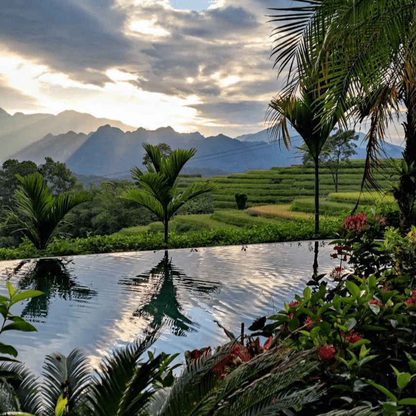 a pool of water with mountains in the background